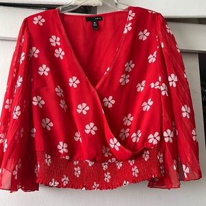 Aqua red print top with elastic waist and pleated sleeves. Size large